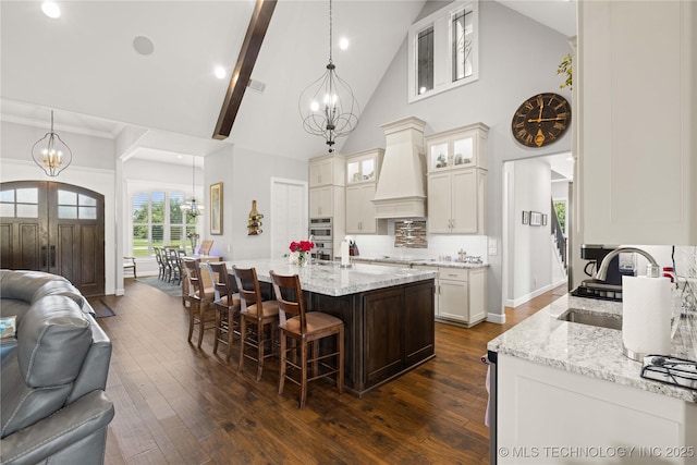 1580 Dawson Dr, Fort Gibson, OK 74434 - kitchen featuring a chandelier, a sink, open floor plan, high vaulted ceiling, and a kitchen bar