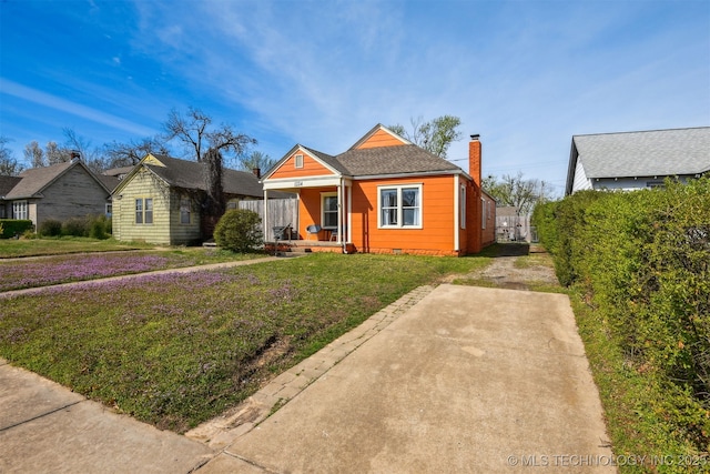 1224 S Columbia Pl, Tulsa, OK 74104 - view of front facade with a porch, a front lawn, a chimney, and crawl space