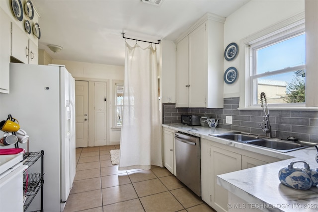 1224 S Columbia Pl, Tulsa, OK 74104 - kitchen with dishwasher, a sink, light countertops, and tasteful backsplash