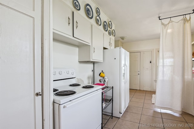1224 S Columbia Pl, Tulsa, OK 74104 - kitchen featuring white appliances, light tile patterned floors, and white cabinets