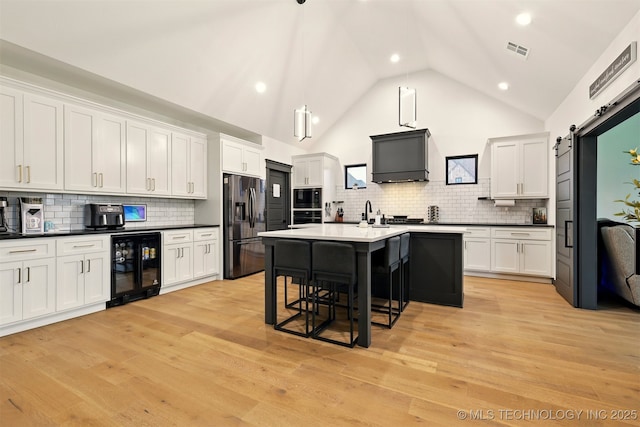 5807 E 128th St S, Bixby, OK 74008 - kitchen with built in microwave, beverage cooler, refrigerator with ice dispenser, oven, and a breakfast bar area