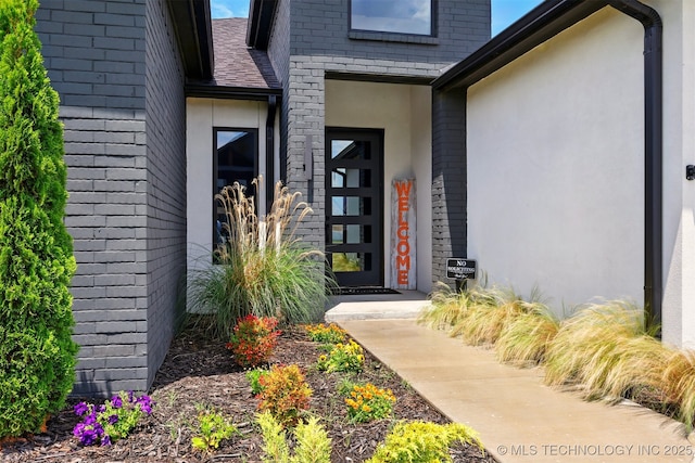 5807 E 128th St S, Bixby, OK 74008 - doorway to property with stucco siding and brick siding