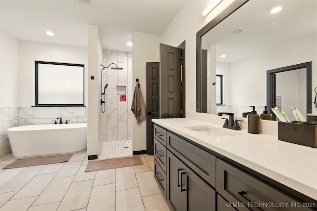 5807 E 128th St S, Bixby, OK 74008 - bathroom with tiled shower, vanity, a freestanding bath, recessed lighting, and tile patterned floors