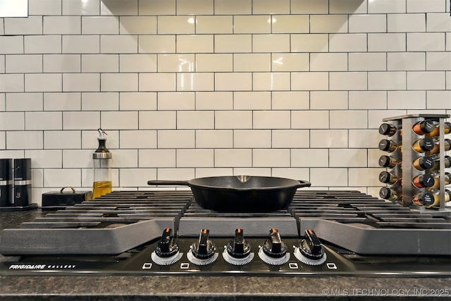 5807 E 128th St S, Bixby, OK 74008 - kitchen view of decorative backsplash, stainless steel gas cooktop, and dark countertops