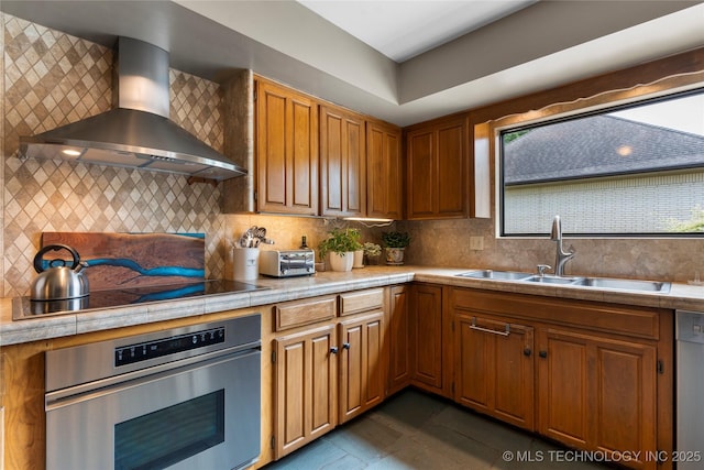 6232 S Jamestown Ave, Tulsa, OK 74136 - kitchen with stainless steel appliances, wall chimney range hood, a sink, and healthy amount of natural light