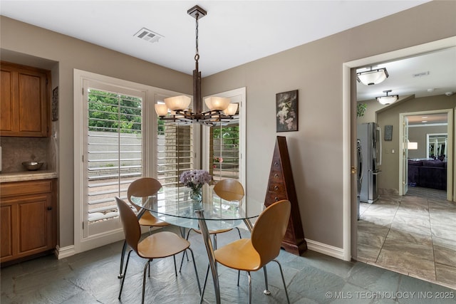 6232 S Jamestown Ave, Tulsa, OK 74136 - dining area with a chandelier and baseboards
