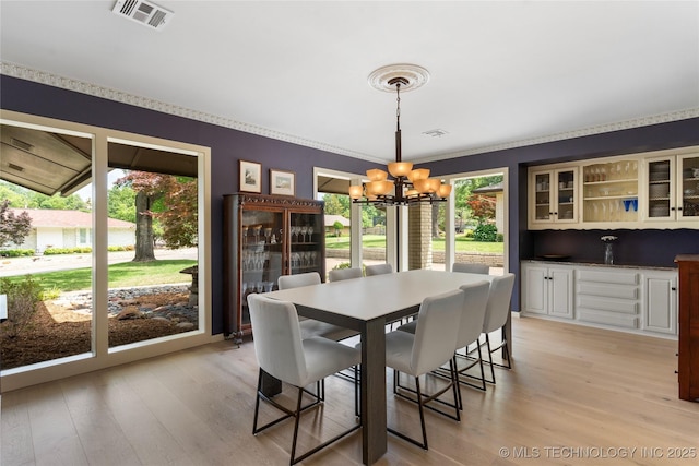 6232 S Jamestown Ave, Tulsa, OK 74136 - dining area with a chandelier and light wood-type flooring