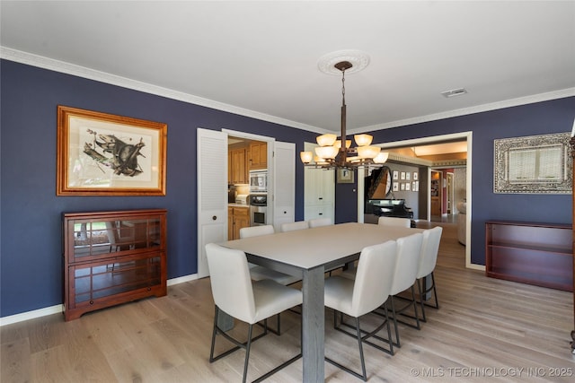 6232 S Jamestown Ave, Tulsa, OK 74136 - dining area featuring a chandelier, light wood finished floors, crown molding, and baseboards