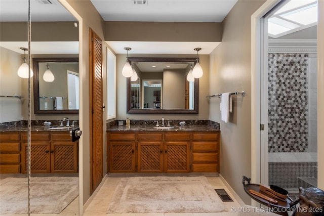6232 S Jamestown Ave, Tulsa, OK 74136 - full bath featuring vanity, baseboards, and tiled shower