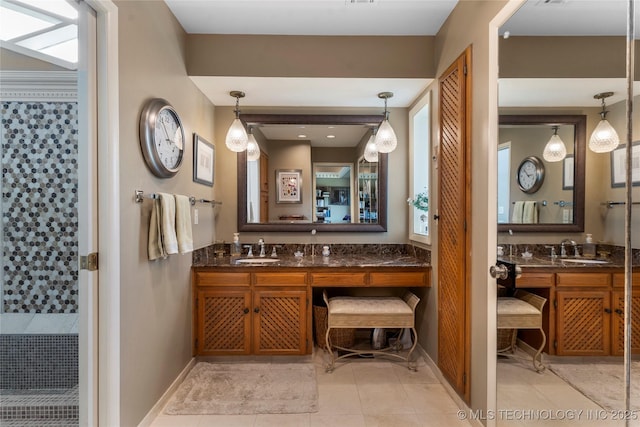 6232 S Jamestown Ave, Tulsa, OK 74136 - bathroom featuring vanity, tiled shower, tile patterned flooring, and baseboards