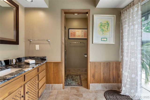 6232 S Jamestown Ave, Tulsa, OK 74136 - bathroom featuring vanity, a wainscoted wall, and tile patterned flooring