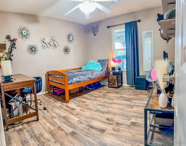 418847 E 1208th Rd, Eufaula, OK 74432 - bedroom with wood finished floors, baseboards, and a ceiling fan