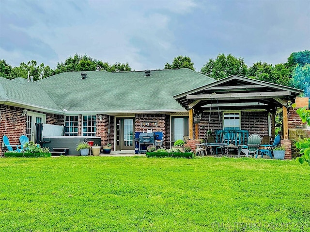 418847 E 1208th Rd, Eufaula, OK 74432 - back of house featuring brick siding, a lawn, a shingled roof, and a gazebo