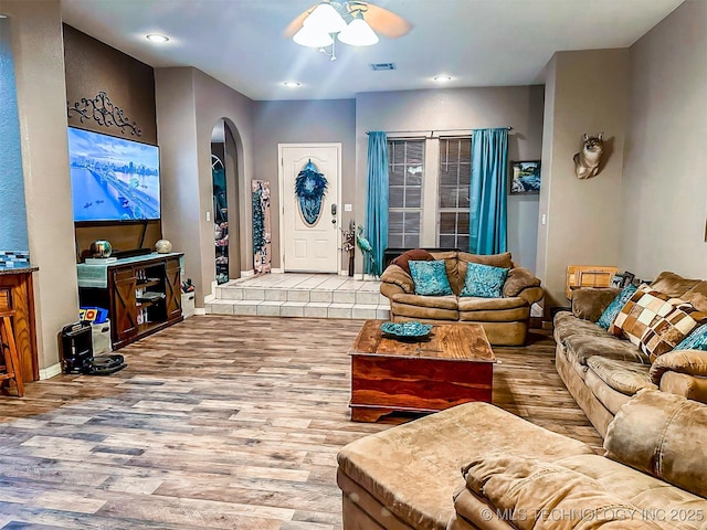 418847 E 1208th Rd, Eufaula, OK 74432 - living room featuring arched walkways, wood finished floors, ceiling fan, baseboards, and recessed lighting