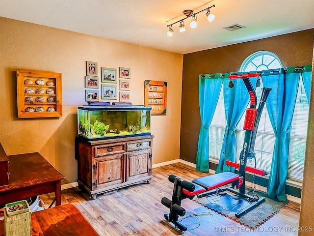 418847 E 1208th Rd, Eufaula, OK 74432 - exercise room featuring wood finished floors and baseboards