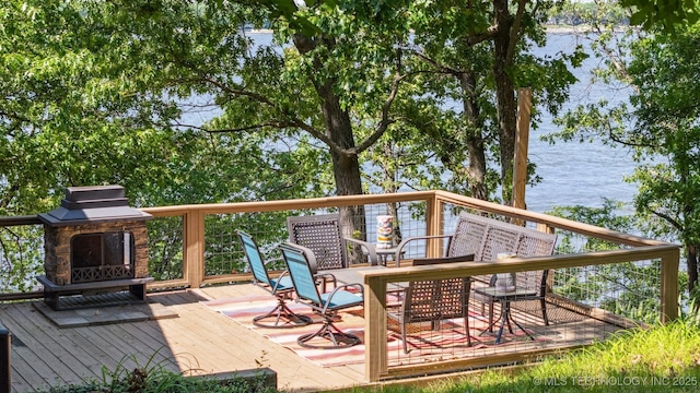 55890 E 315th Rd, Jay, OK 74346 - wooden terrace featuring a water view, outdoor dining area, and an outdoor stone fireplace