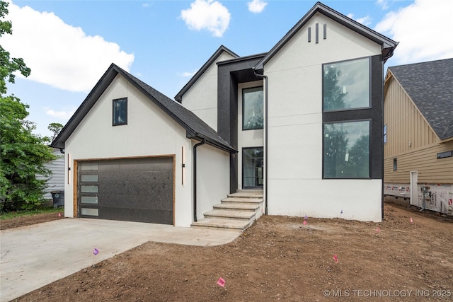 3917 S Madison Ave, Tulsa, OK 74105 - view of front of property with stucco siding, driveway, and a garage