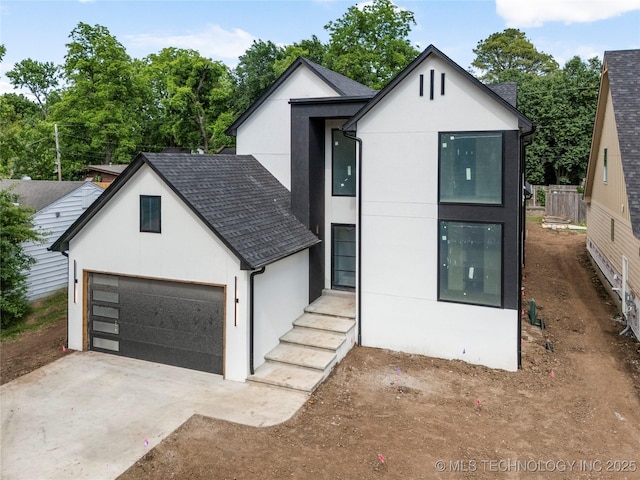 3917 S Madison Ave, Tulsa, OK 74105 - view of front of home with stucco siding, driveway, and roof with shingles