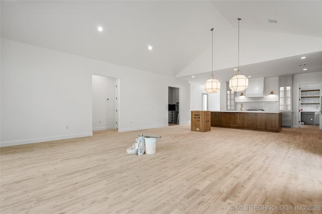 3917 S Madison Ave, Tulsa, OK 74105 - unfurnished living room featuring light wood-style floors, high vaulted ceiling, recessed lighting, and baseboards