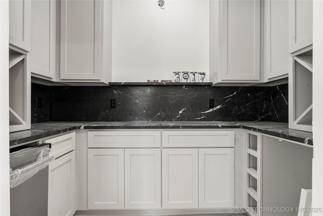 3917 S Madison Ave, Tulsa, OK 74105 - kitchen with tasteful backsplash, white cabinetry, and stainless steel dishwasher