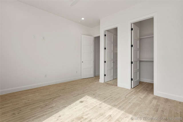 3917 S Madison Ave, Tulsa, OK 74105 - unfurnished bedroom featuring light wood-type flooring, baseboards, a spacious closet, recessed lighting, and a closet