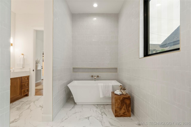 3917 S Madison Ave, Tulsa, OK 74105 - full bathroom featuring a freestanding bath, vanity, marble finish flooring, recessed lighting, and tile walls