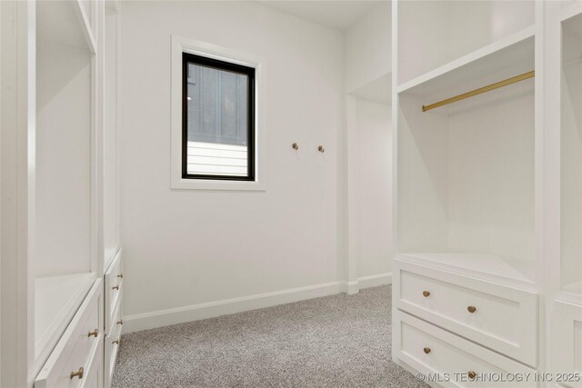 3917 S Madison Ave, Tulsa, OK 74105 - walk in closet featuring light colored carpet