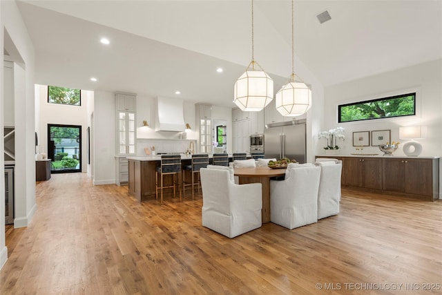 3917 S Madison Ave, Tulsa, OK 74105 - dining room with high vaulted ceiling, healthy amount of natural light, light wood finished floors, and recessed lighting