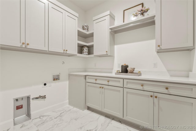 3917 S Madison Ave, Tulsa, OK 74105 - washroom featuring cabinet space, hookup for an electric dryer, light marble finish floors, and hookup for a washing machine