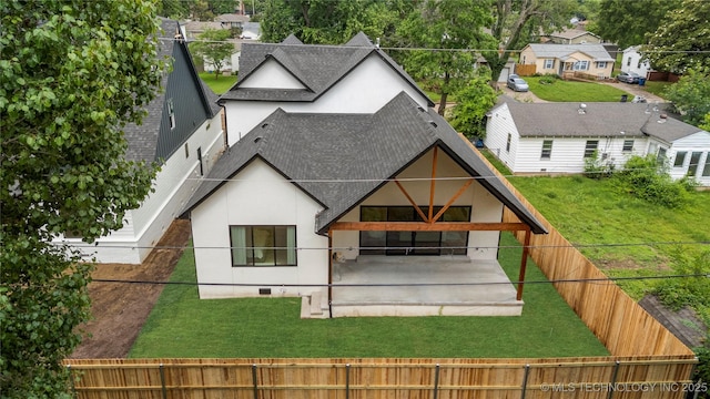 3917 S Madison Ave, Tulsa, OK 74105 - rear view of house with a shingled roof, a fenced backyard, stucco siding, and a patio