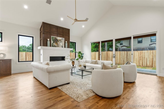 3917 S Madison Ave, Tulsa, OK 74105 - living room featuring high vaulted ceiling, healthy amount of natural light, a fireplace, a ceiling fan, and recessed lighting