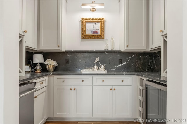 3917 S Madison Ave, Tulsa, OK 74105 - kitchen featuring beverage cooler, decorative backsplash, white cabinetry, and dark stone counters