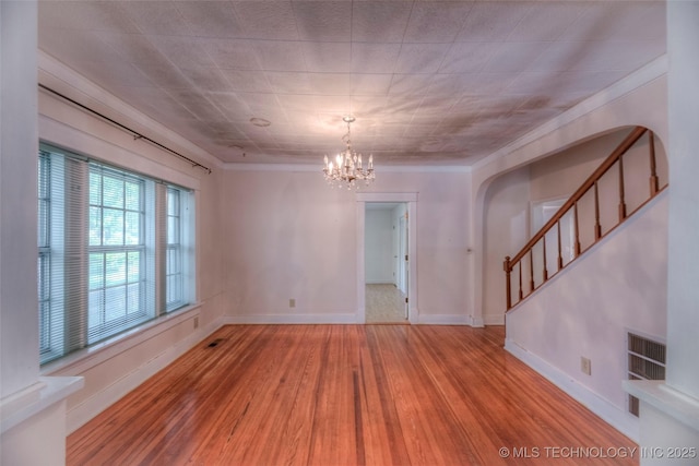 234 E Freeport St, Broken Arrow, OK 74012 - empty room featuring wood finished floors, stairs, a chandelier, crown molding, and baseboards