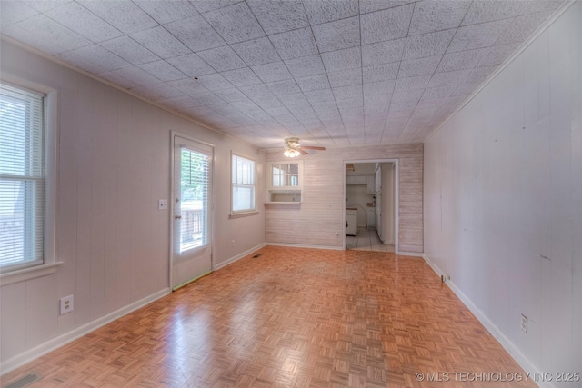 234 E Freeport St, Broken Arrow, OK 74012 - unfurnished room with baseboards, a ceiling fan, and wooden walls