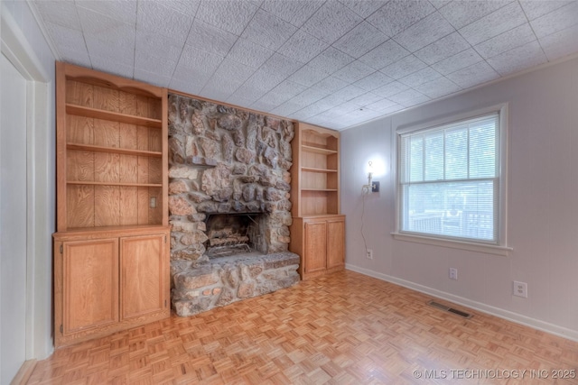 234 E Freeport St, Broken Arrow, OK 74012 - unfurnished living room featuring built in features, a stone fireplace, and baseboards