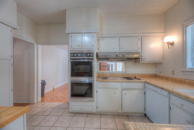 234 E Freeport St, Broken Arrow, OK 74012 - kitchen featuring white appliances, light tile patterned floors, light countertops, white cabinets, and under cabinet range hood