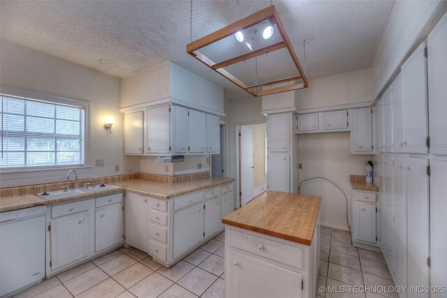 234 E Freeport St, Broken Arrow, OK 74012 - kitchen with white dishwasher, a sink, light tile patterned floors, a textured ceiling, and white cabinets