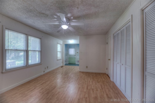 234 E Freeport St, Broken Arrow, OK 74012 - unfurnished bedroom featuring a textured ceiling, light wood finished floors, baseboards, ensuite bath, and ceiling fan