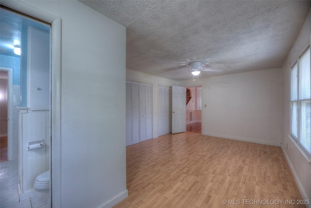 234 E Freeport St, Broken Arrow, OK 74012 - unfurnished room featuring a textured ceiling, wood finished floors, a ceiling fan, and plenty of natural light