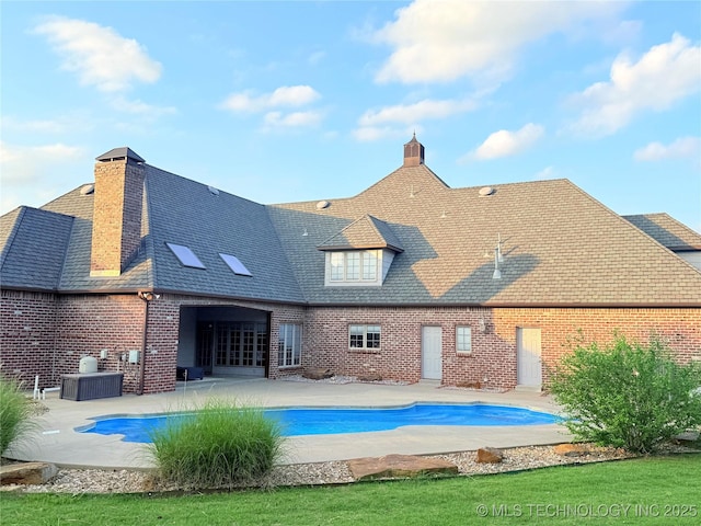 4224 S 69th W Ave, Tulsa, OK 74107 - back of house with brick siding, a patio area, and an outdoor pool