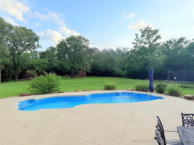 4224 S 69th W Ave, Tulsa, OK 74107 - swimming pool with a trampoline, a playground, a patio, a lawn, and view of scattered trees