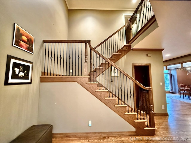4224 S 69th W Ave, Tulsa, OK 74107 - stairs featuring wood finished floors, baseboards, crown molding, and a high ceiling