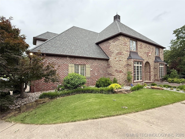 4224 S 69th W Ave, Tulsa, OK 74107 - view of property exterior featuring a yard, brick siding, a high end roof, and a chimney