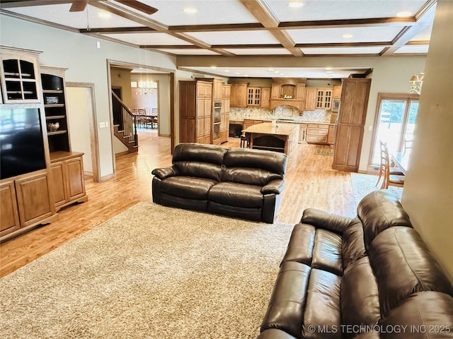 4224 S 69th W Ave, Tulsa, OK 74107 - living room featuring light wood-type flooring, ceiling fan, coffered ceiling, stairway, and recessed lighting