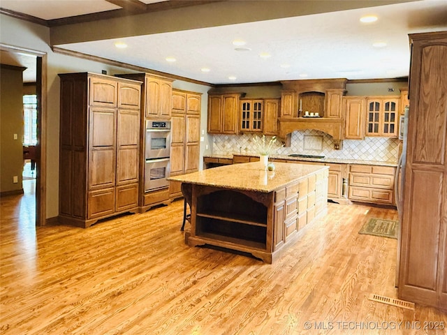 4224 S 69th W Ave, Tulsa, OK 74107 - kitchen featuring open shelves, stainless steel double oven, ornamental molding, light wood finished floors, and a center island