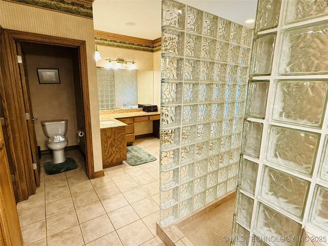4224 S 69th W Ave, Tulsa, OK 74107 - full bathroom featuring walk in shower, tile patterned flooring, vanity, and toilet
