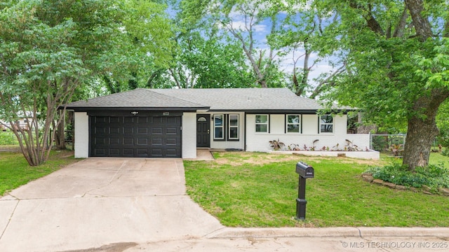 602 S Sunset Dr, Claremore, OK 74017 - view of front of property with a garage, brick siding, driveway, and a front yard