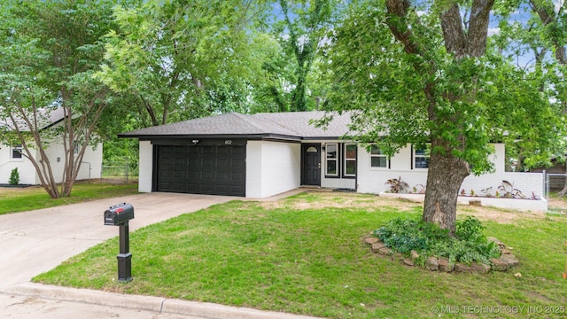 602 S Sunset Dr, Claremore, OK 74017 - view of front facade featuring a garage, concrete driveway, brick siding, and a shingled roof