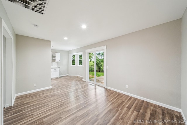 602 S Sunset Dr, Claremore, OK 74017 - unfurnished living room featuring baseboards, recessed lighting, and light wood finished floors