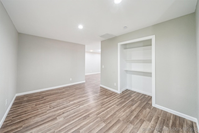 602 S Sunset Dr, Claremore, OK 74017 - spare room with light wood finished floors, baseboards, recessed lighting, and built in shelves